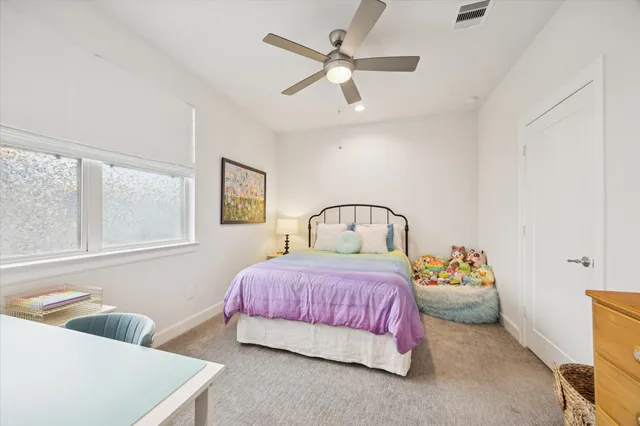 a bedroom with a bed couch and window