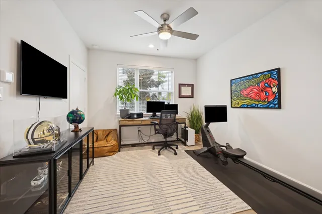 a living room with furniture a window and a flat screen tv