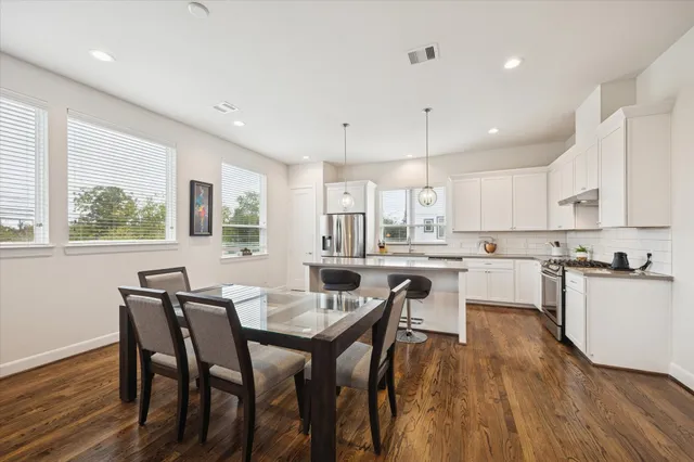 a view of a dining room with furniture and wooden floor
