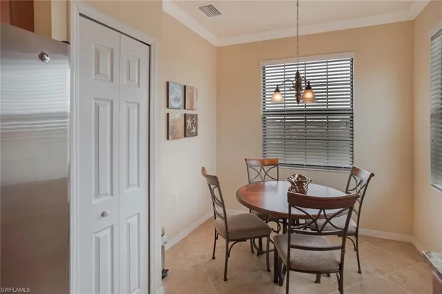 a dining room with furniture and window