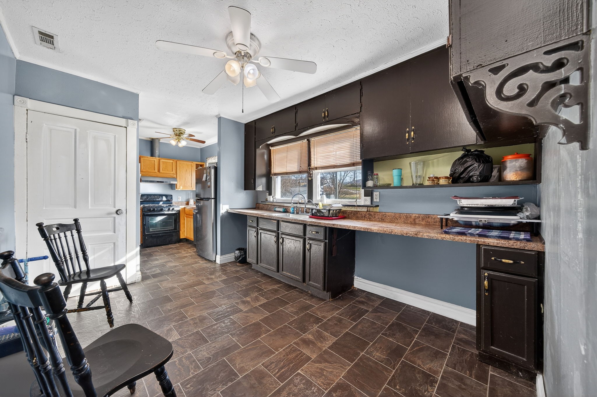 7 Marshall Street Sparta, TN 38583 - Photo 13 of 36 a kitchen with stainless steel appliances granite countertop a stove top oven a sink a dining table and chairs with wooden floor