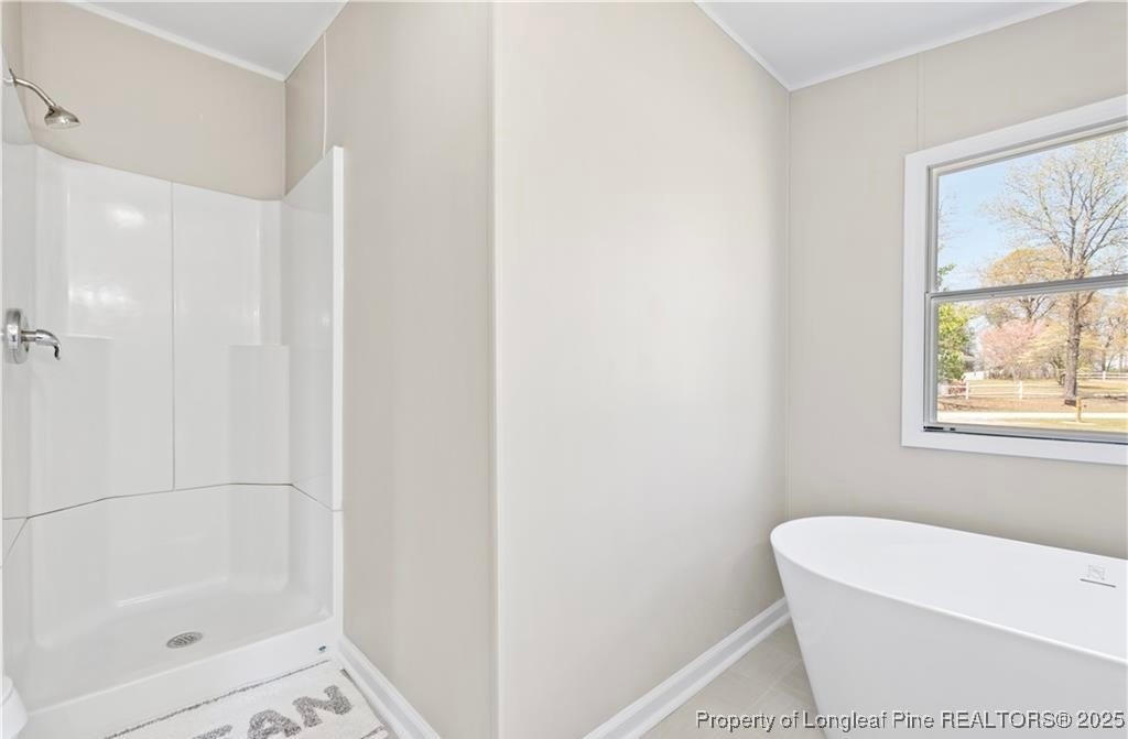 292 Grenada Road Fayetteville, NC 28306 - Photo 13 of 37 a white bath tub sitting next to a small window