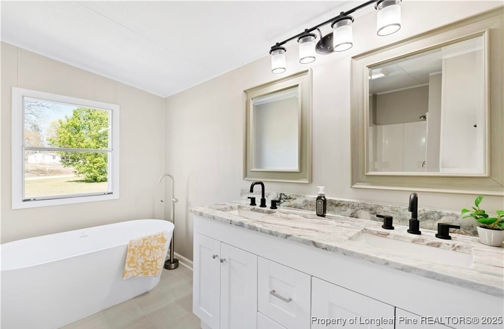 292 Grenada Road Fayetteville, NC 28306 - Photo 14 of 37 a bathroom with a granite countertop sink mirror and a bathtub