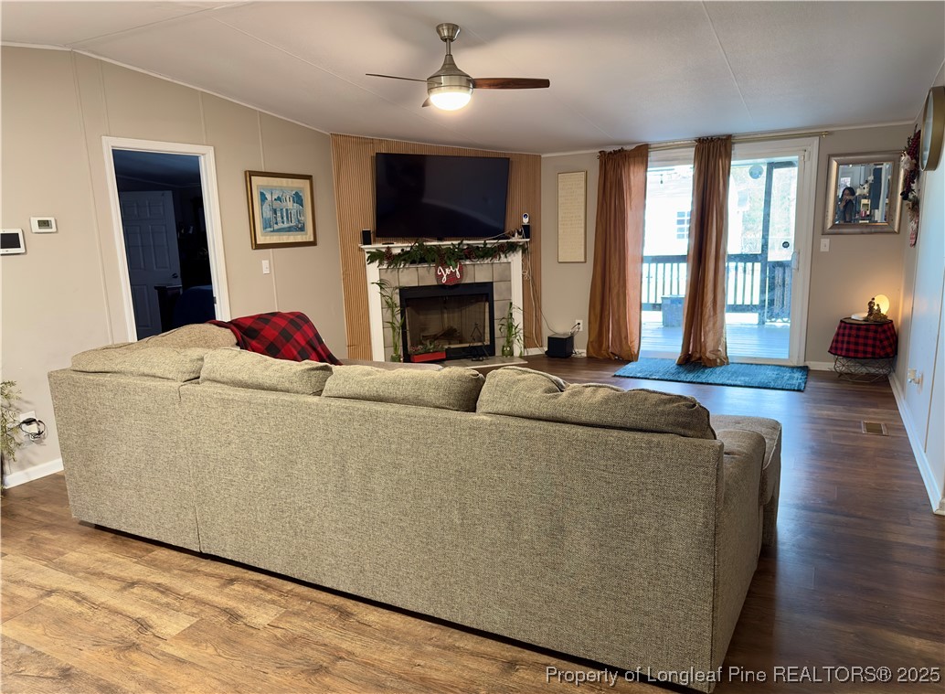 292 Grenada Road Fayetteville, NC 28306 - Photo 18 of 37 a living room with furniture a fireplace and a flat screen tv