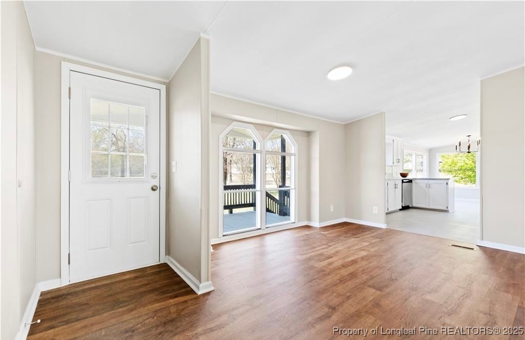 292 Grenada Road Fayetteville, NC 28306 - Photo 2 of 37 a view of a big room with wooden floor and windows
