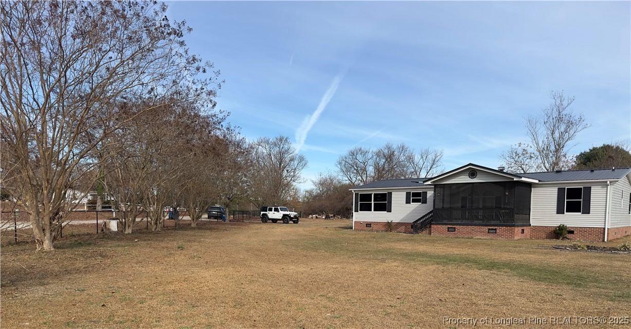292 Grenada Road Fayetteville, NC 28306 - Photo 33 of 37 a front view of a house with a yard and garage