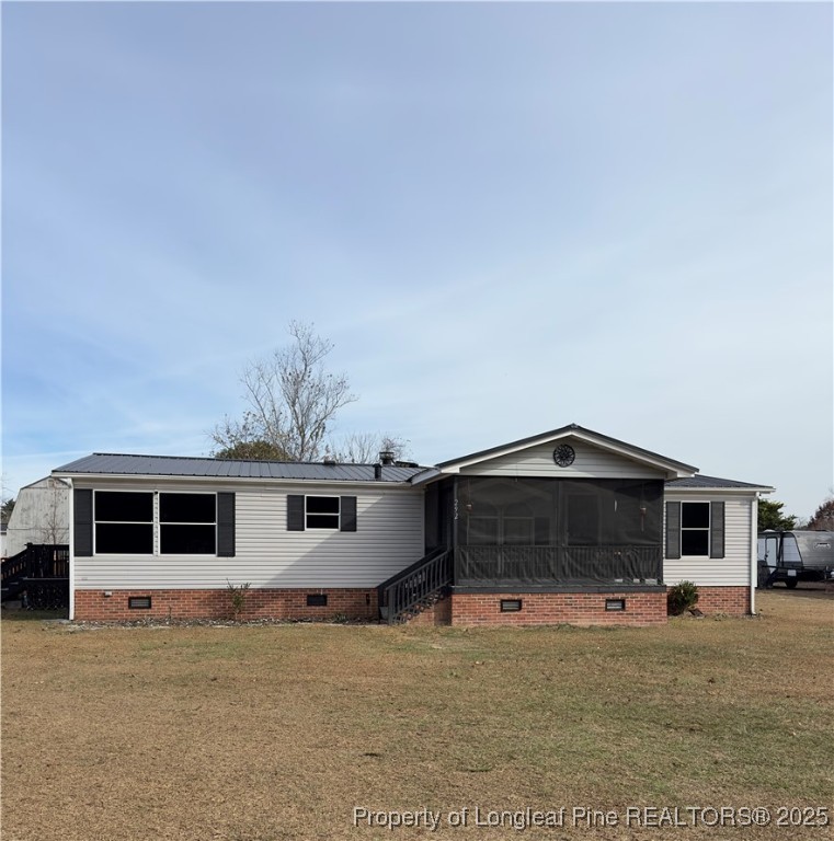 292 Grenada Road Fayetteville, NC 28306 - Photo 36 of 37 a front view of a house with a yard and garage