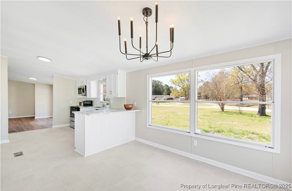 292 Grenada Road Fayetteville, NC 28306 - Photo 6 of 37 a view of kitchen with furniture and large window