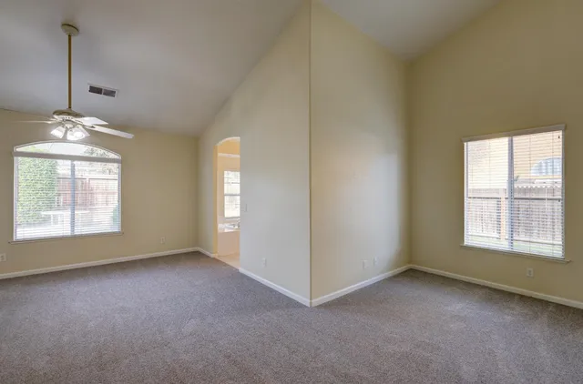 a view of a livingroom with a chandelier fan and a bathroom