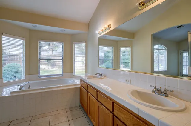 a spacious bathroom with a double vanity sink mirror and
