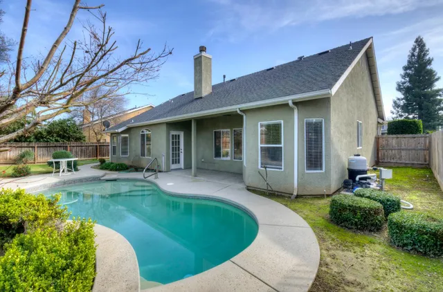 a view of a swimming pool with a yard