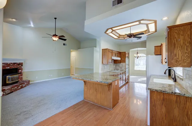 a kitchen with stainless steel appliances granite countertop a stove and a sink