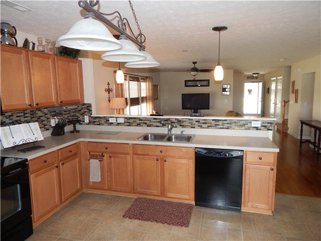 3960 Stephens Ridge Way Antioch, TN 37013 - Photo 9 of 20 Glass tile backsplash extends above sink and counters overlooking livingroom area...great for entertaining.