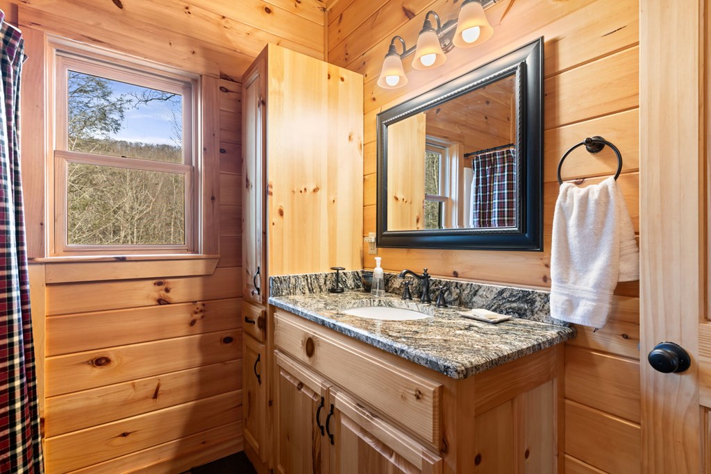 197 Cashes Valley Cherry Log, GA 30522 - Photo 21 of 67 a bathroom with a granite countertop sink and a mirror