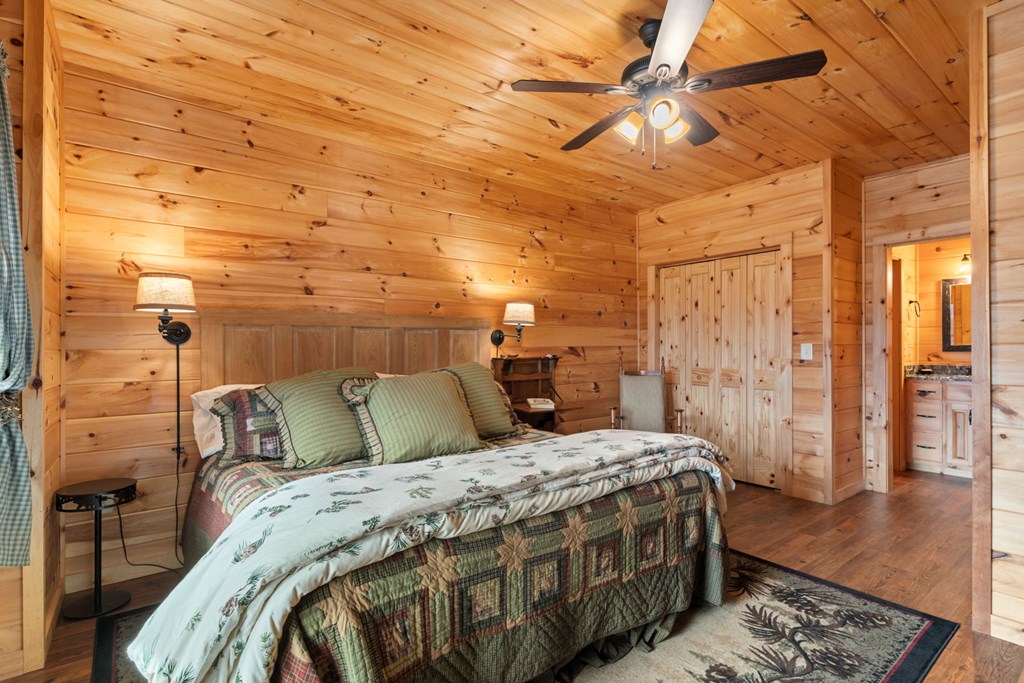197 Cashes Valley Cherry Log, GA 30522 - Photo 37 of 67 a bedroom with a bed a rug and wooden floor