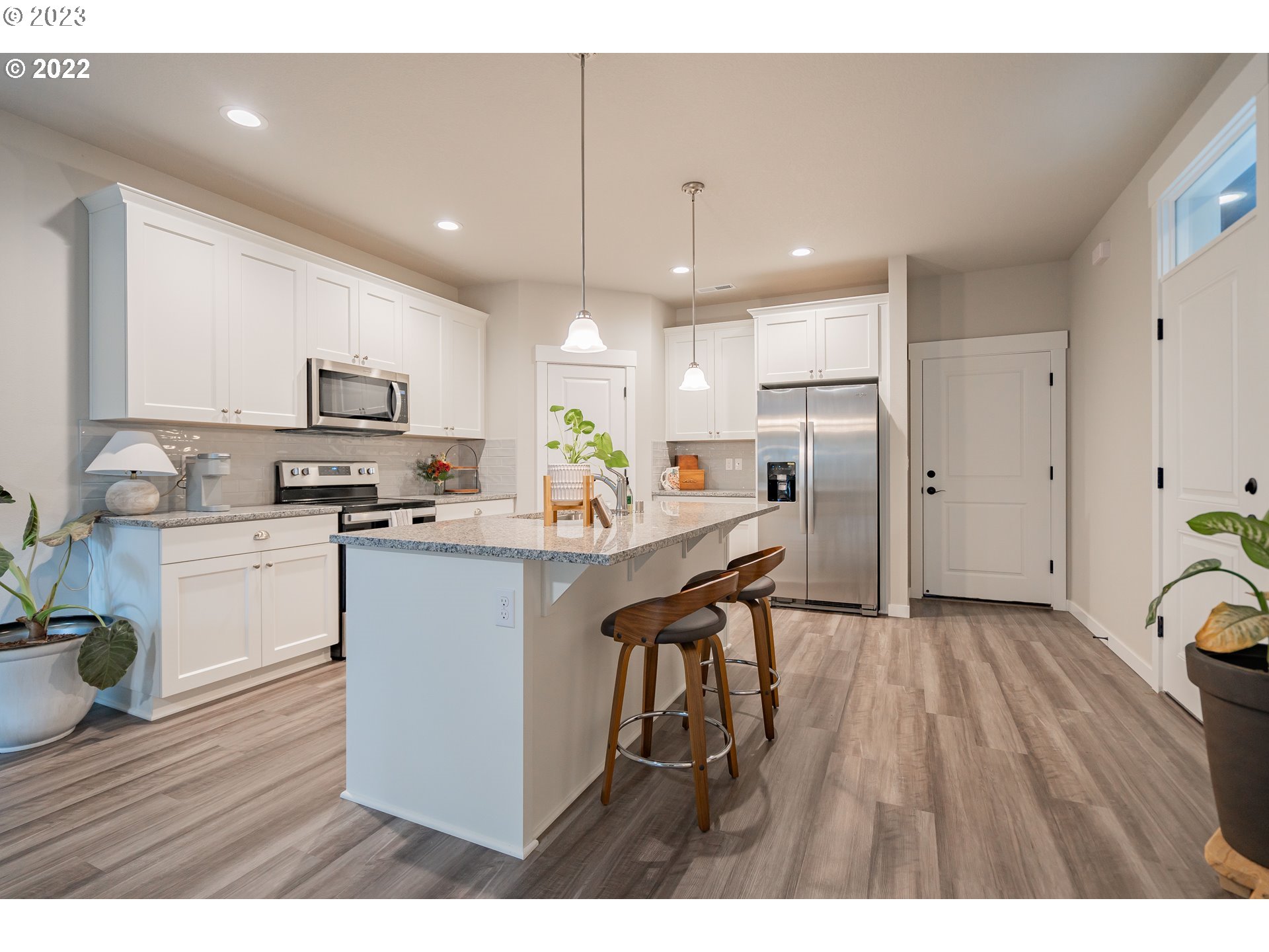 7209 South 13th Street Ridgefield, WA 98642 - Photo 3 of 7 a kitchen with a refrigerator a sink and cabinets