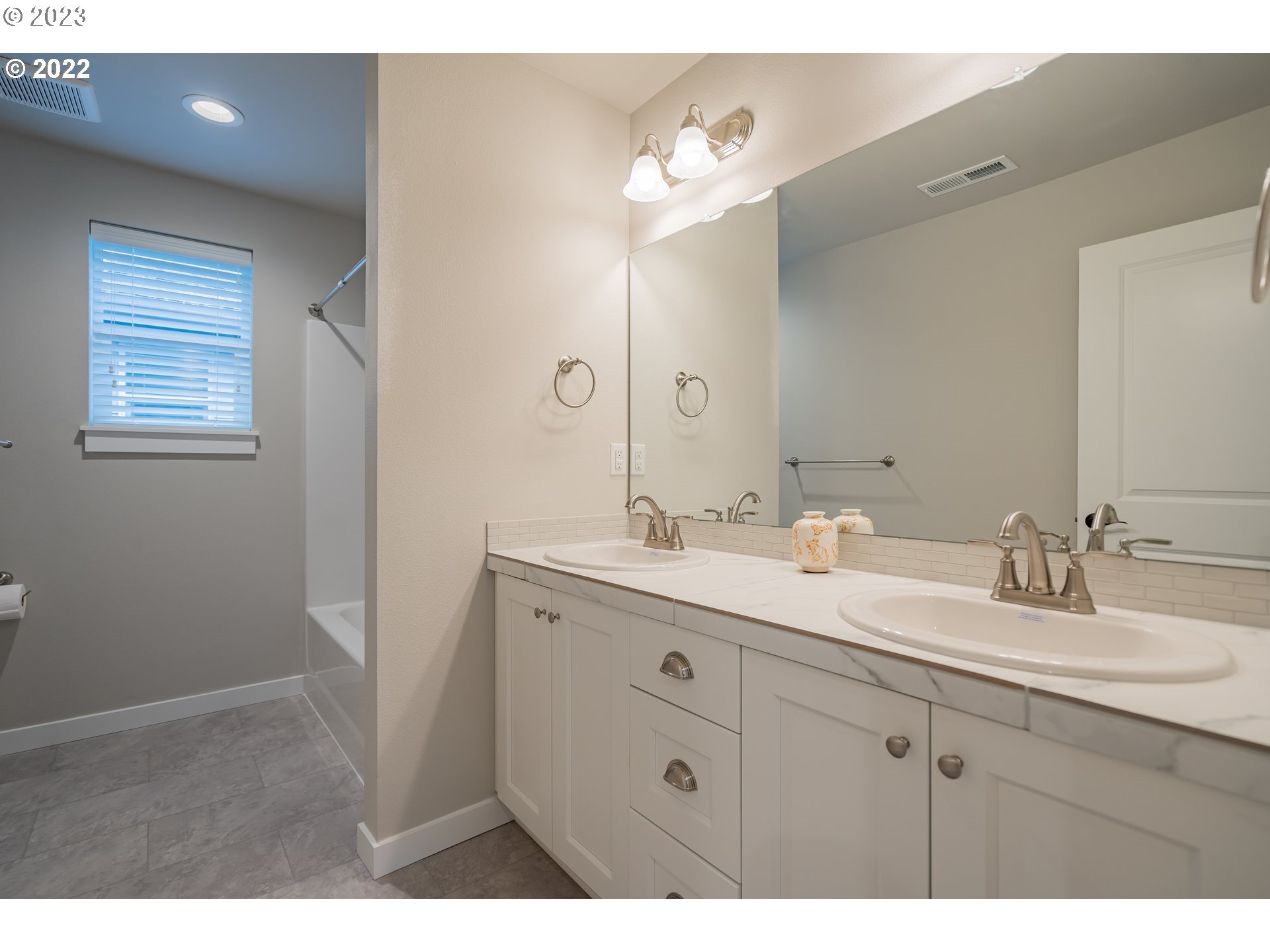 7209 South 13th Street Ridgefield, WA 98642 - Photo 7 of 7 a bathroom with a double vanity sink and mirror