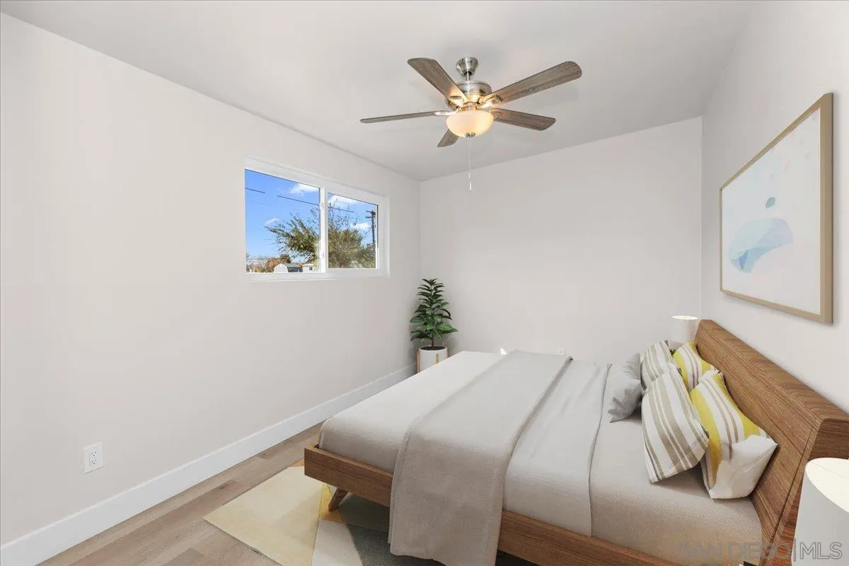 9255 Fairlawn Street Santee, CA 92071 - Photo 12 of 34 a bedroom with a bed and a chandelier