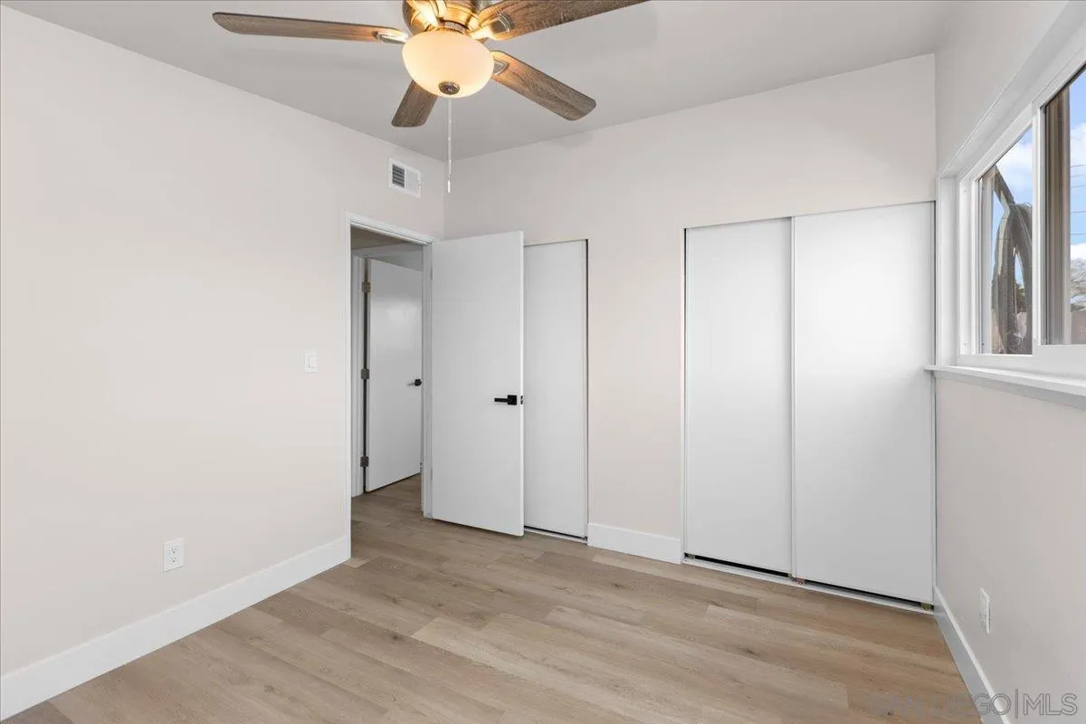 9255 Fairlawn Street Santee, CA 92071 - Photo 13 of 34 an empty room with closet and a chandelier fan