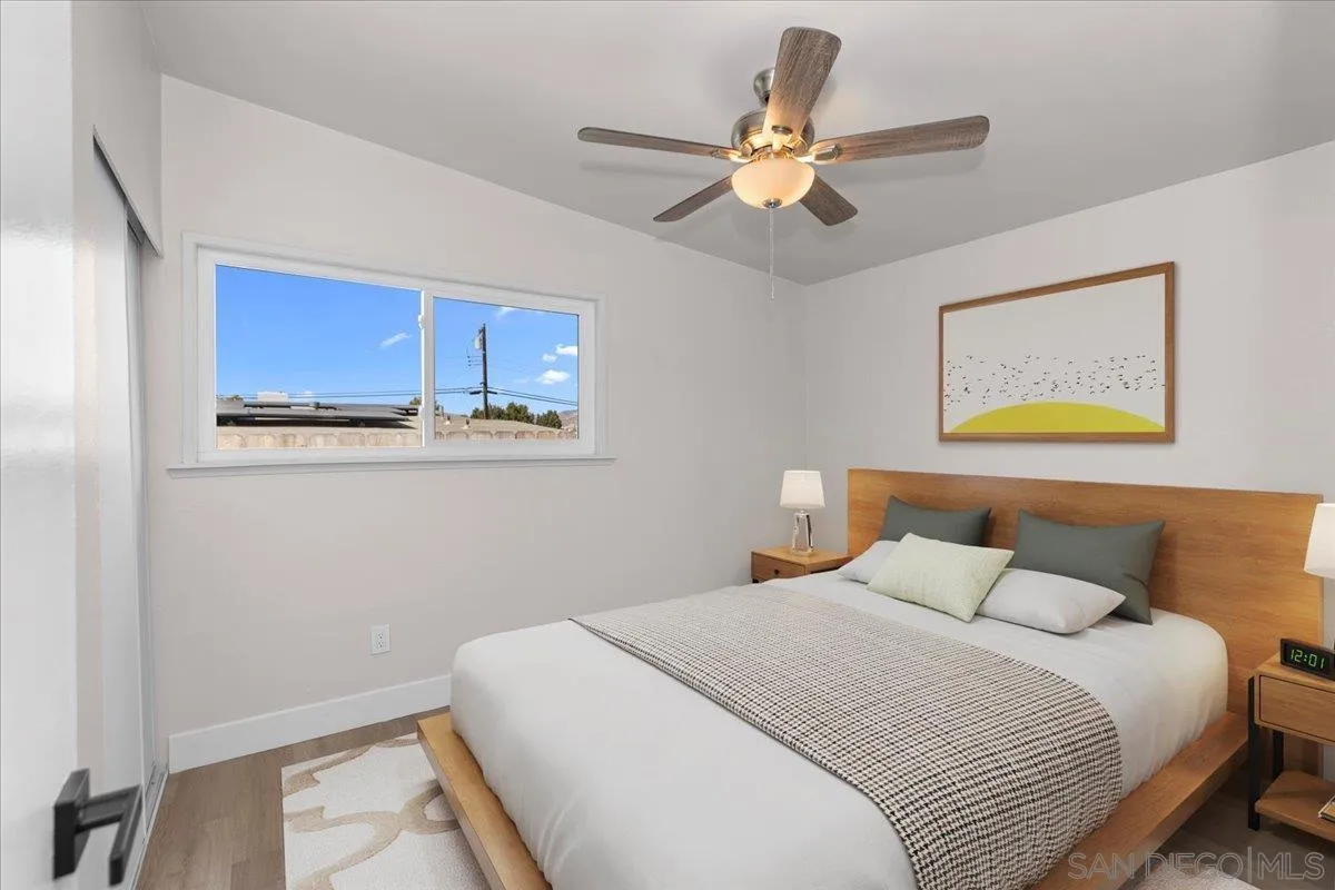 9255 Fairlawn Street Santee, CA 92071 - Photo 14 of 34 a bedroom with a bed and a chandelier