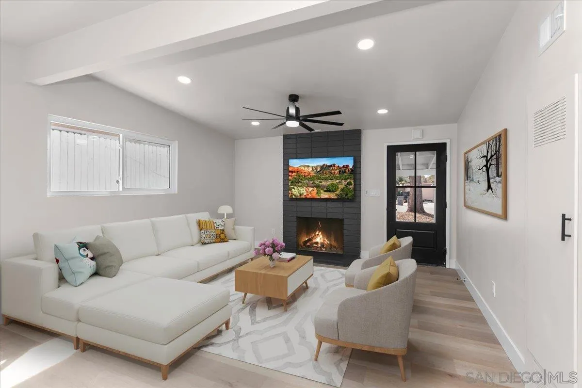 9255 Fairlawn Street Santee, CA 92071 - Photo 2 of 34 a living room with furniture a fireplace and a flat screen tv