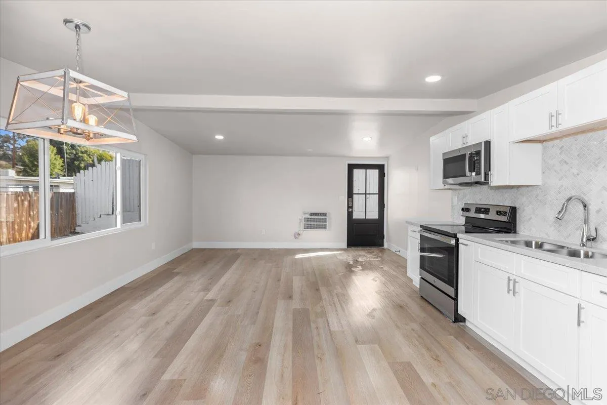 9255 Fairlawn Street Santee, CA 92071 - Photo 24 of 34 a kitchen with granite countertop a stove a sink and a refrigerator