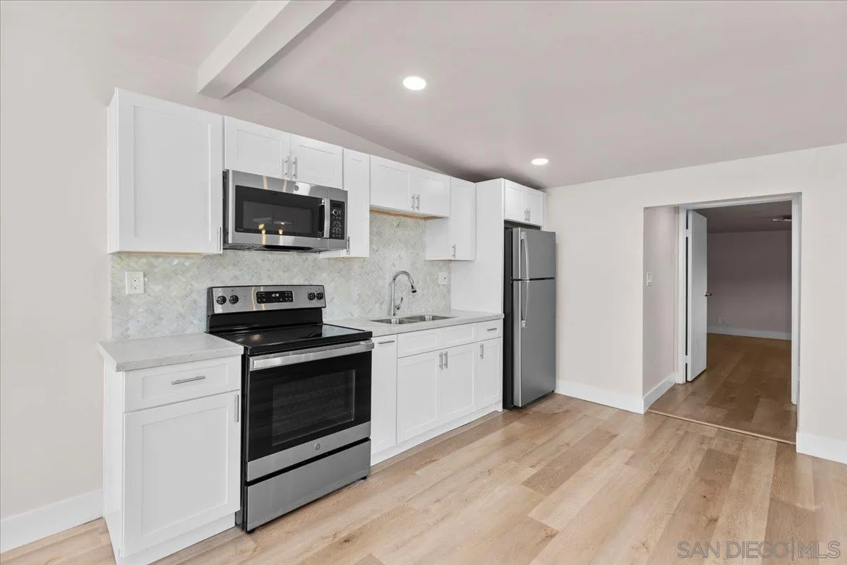 9255 Fairlawn Street Santee, CA 92071 - Photo 28 of 34 a kitchen with stainless steel appliances a stove sink microwave and refrigerator
