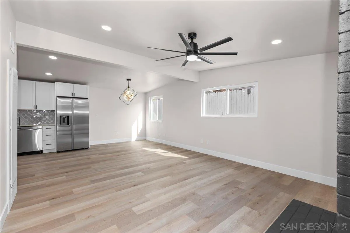 9255 Fairlawn Street Santee, CA 92071 - Photo 3 of 34 a view of a kitchen with a sink a ceiling fan and stainless steel appliances