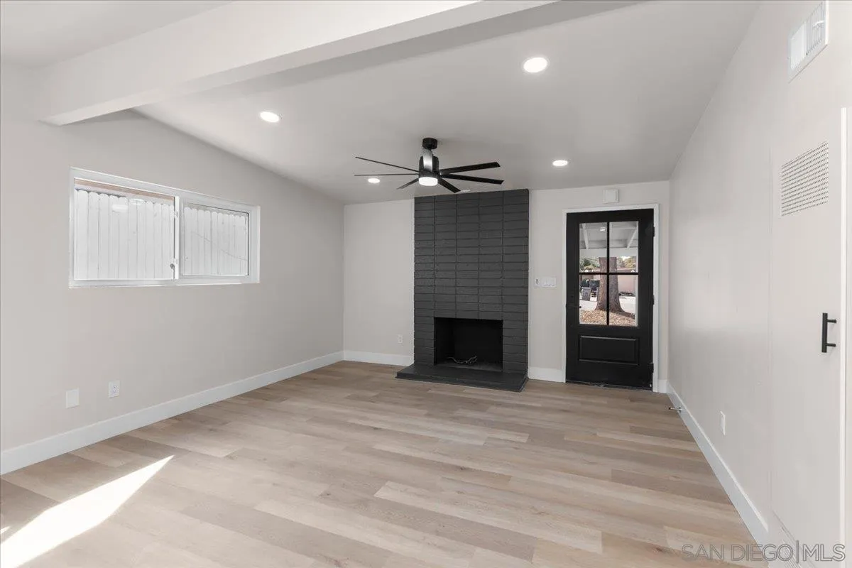 9255 Fairlawn Street Santee, CA 92071 - Photo 5 of 34 an empty room with windows and a fireplace