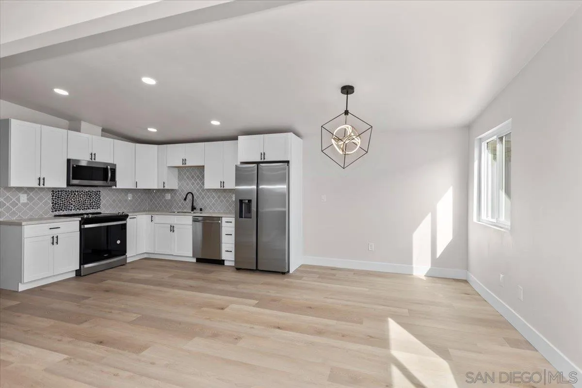 9255 Fairlawn Street Santee, CA 92071 - Photo 7 of 34 a kitchen with stainless steel appliances granite countertop a refrigerator and a stove top oven