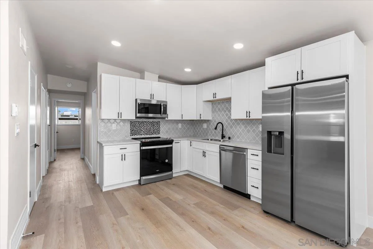 9255 Fairlawn Street Santee, CA 92071 - Photo 8 of 34 a kitchen with a refrigerator and a stove top oven