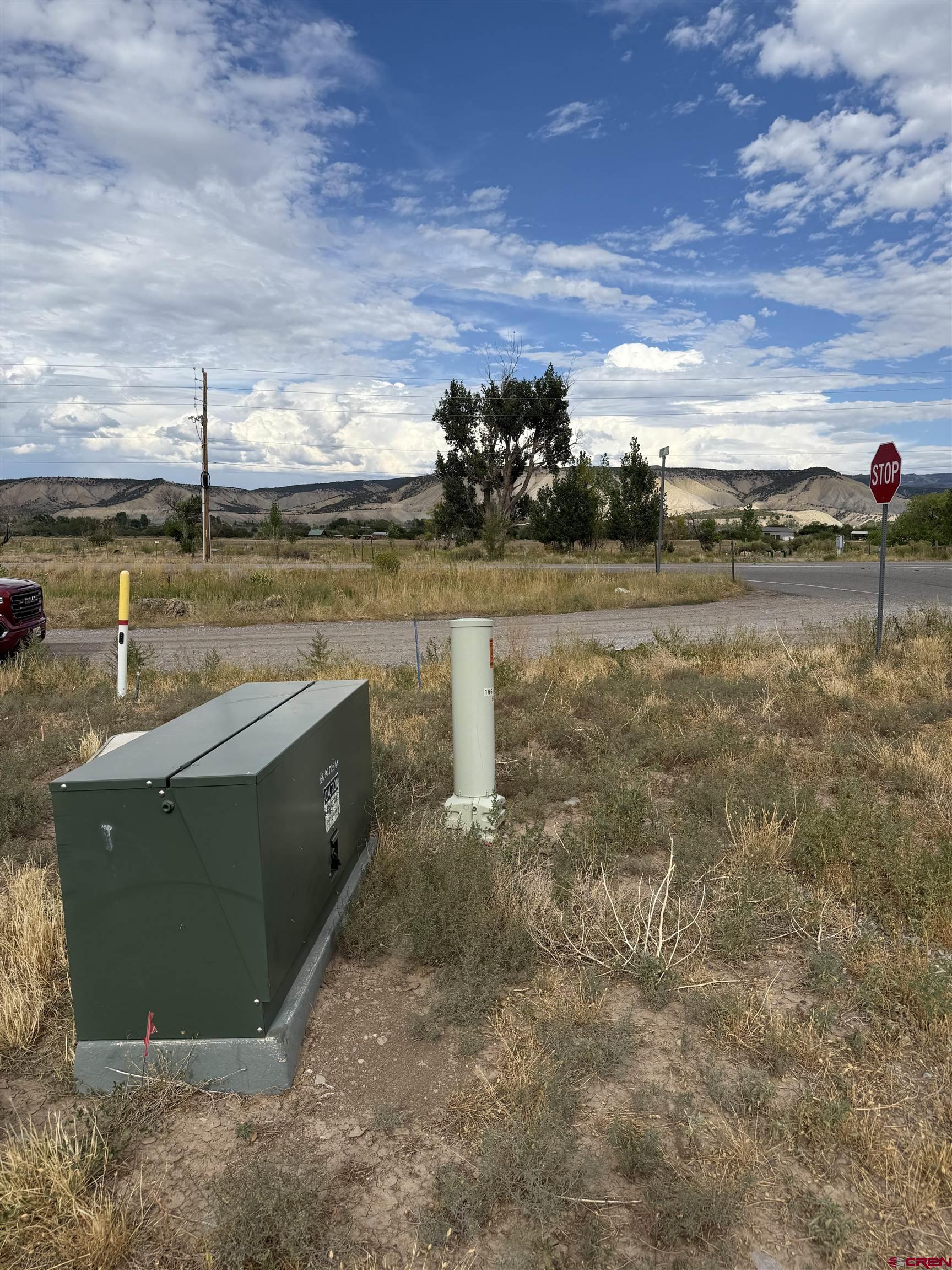 68671 Vernal Road Montrose, CO 81403 - Photo 12 of 13 a view of a lake with a car parked