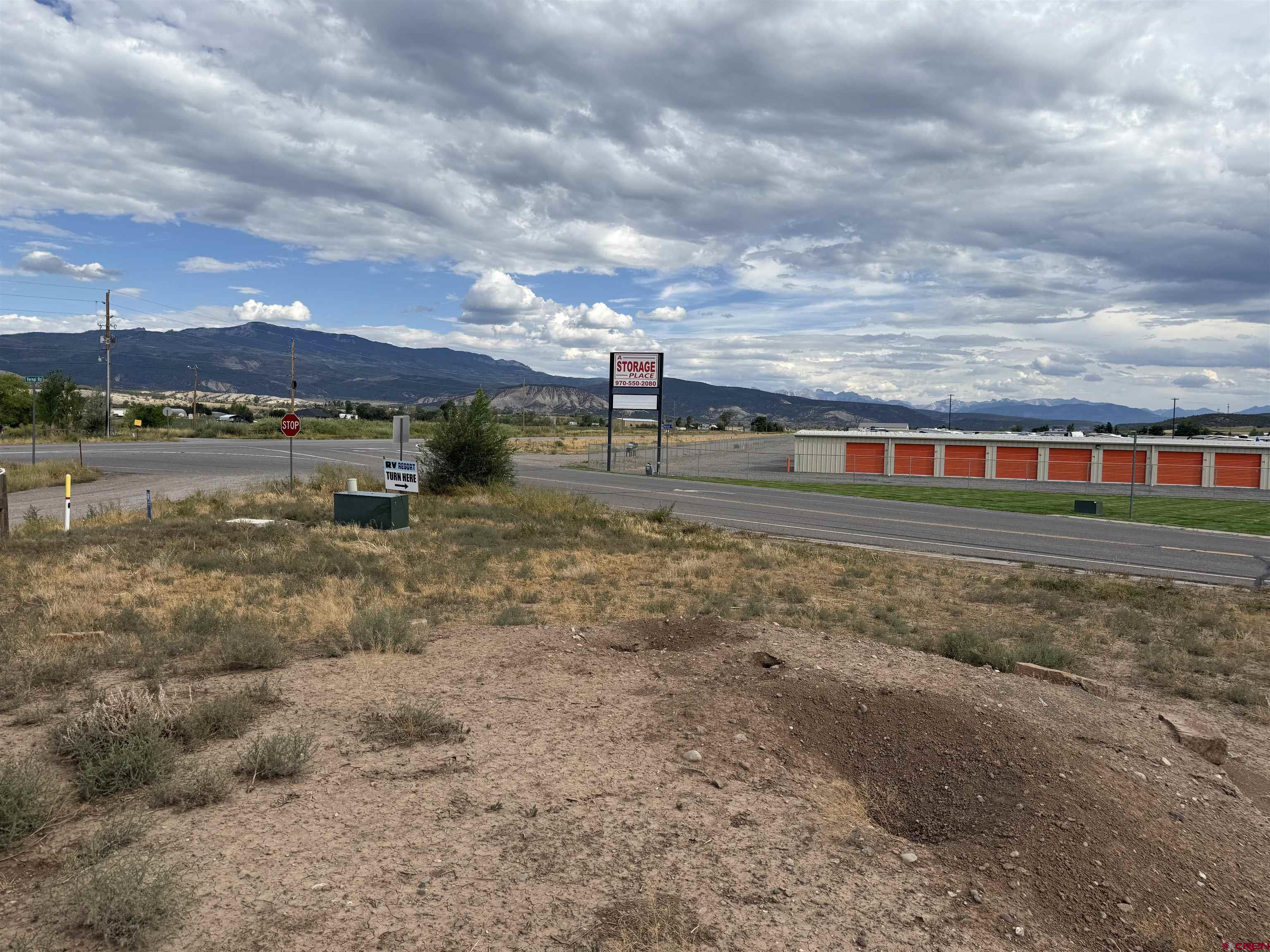 68671 Vernal Road Montrose, CO 81403 - Photo 8 of 13 a view of a big yard next to a building