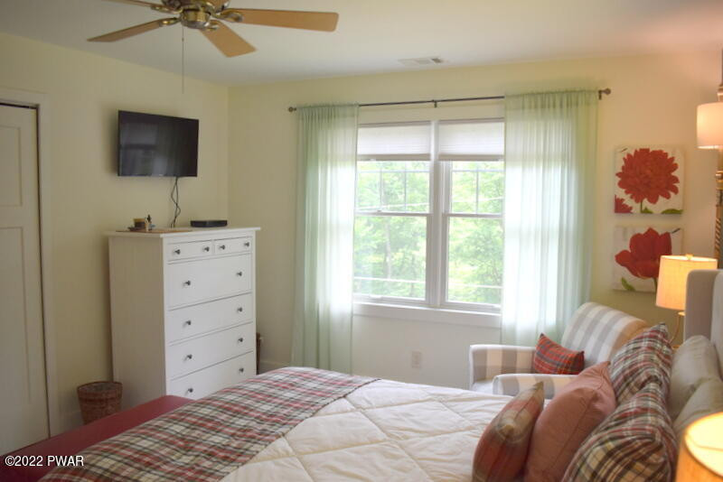 549 Finn Swamp Road Lakeville, PA 18438 - Photo 18 of 35 a bedroom with a bed and a flat tv screen on dresser
