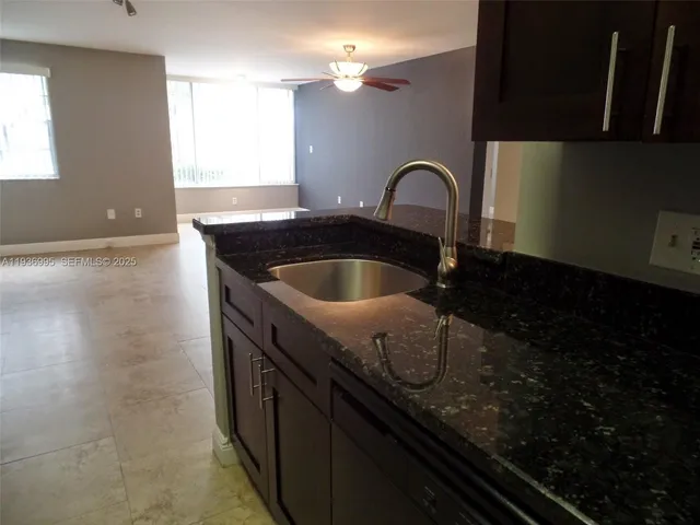 a close view of a sink a counter space and stove in the kitchen