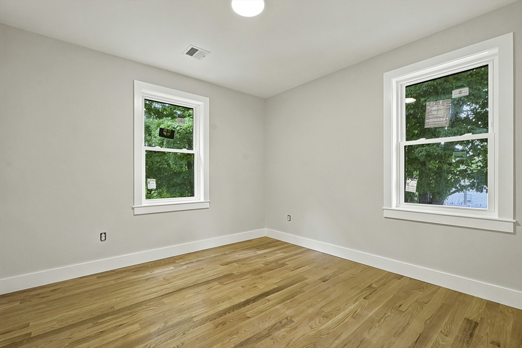 4 Mayhew Street Framingham, MA 01702 - Photo 23 of 42 an empty room with wooden floor and windows