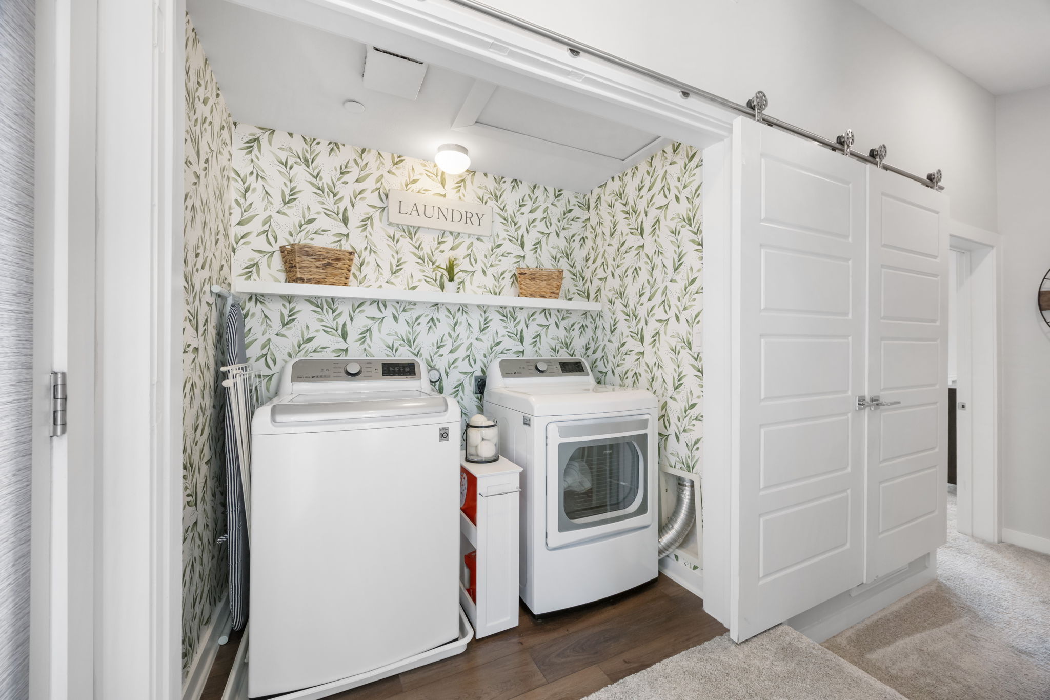 1417 Kramer Lane, Unit 14 Austin, TX 78758 - Photo 25 of 33 Laundry area with a barn door, wallpapered walls, separate washer and dryer, and dark wood finished floors