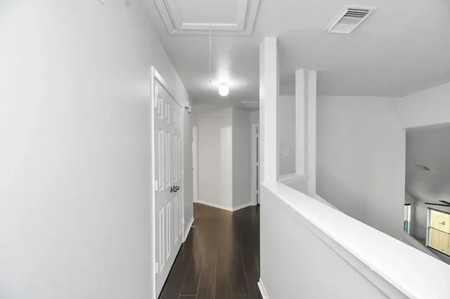a view of hallway with wooden floor