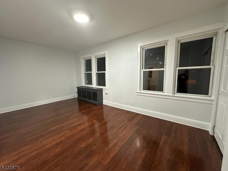 32 Hamilton Avenue, Unit 2 Fairview, NJ 07022 - Photo 20 of 30 a view of empty room with wooden floor and windows