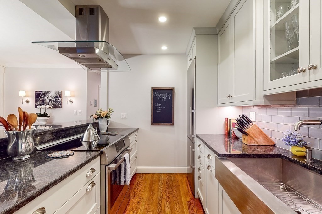 476 Shawmut Avenue, Unit 3 Boston, MA 02118 - Photo 11 of 29 a kitchen with stainless steel appliances granite countertop a sink a stove and a wooden floors