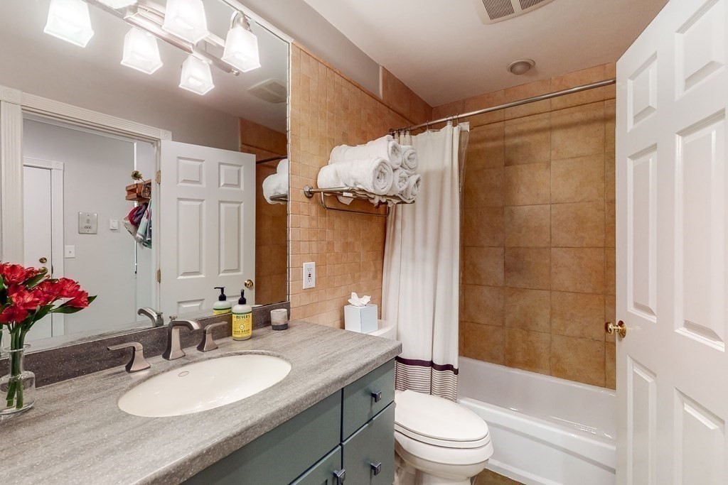 476 Shawmut Avenue, Unit 3 Boston, MA 02118 - Photo 24 of 29 a bathroom with a granite countertop sink toilet mirror and shower