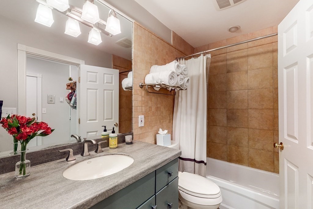 476 Shawmut Avenue, Unit 3 Boston, MA 02118 - Photo 25 of 29 a bathroom with a sink vanity mirror and toilet