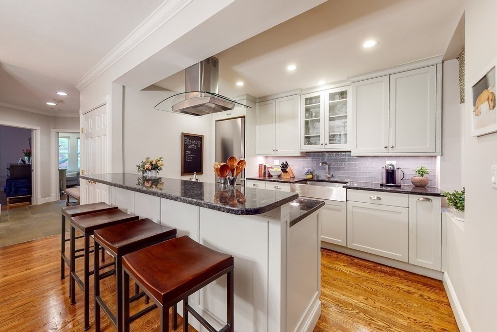 476 Shawmut Avenue, Unit 3 Boston, MA 02118 - Photo 9 of 29 a kitchen with stainless steel appliances kitchen island granite countertop a sink and cabinets