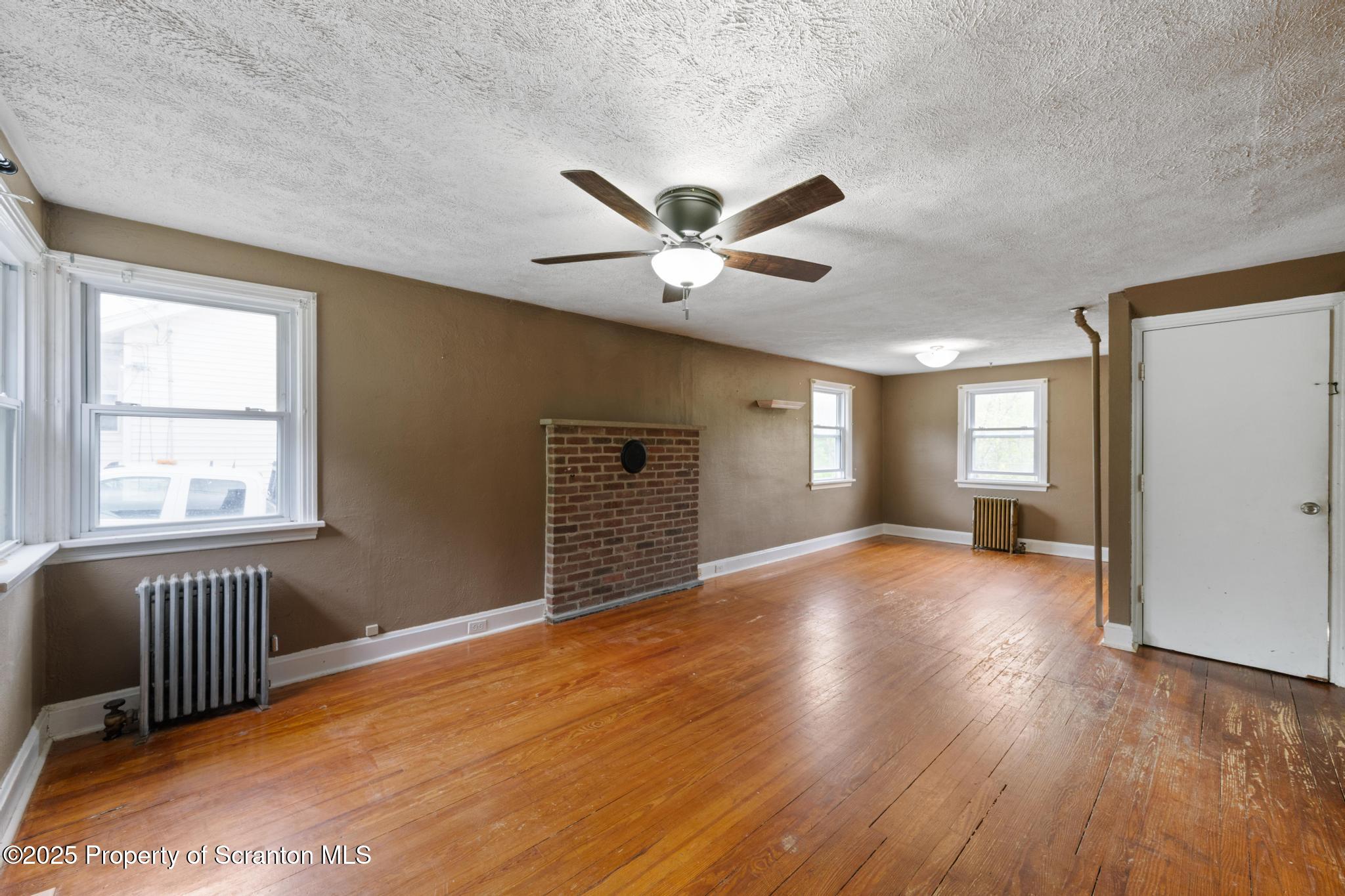 730 Chase Road Shavertown, PA 18708 - Photo 15 of 43 a view of an empty room with a window and wooden floor
