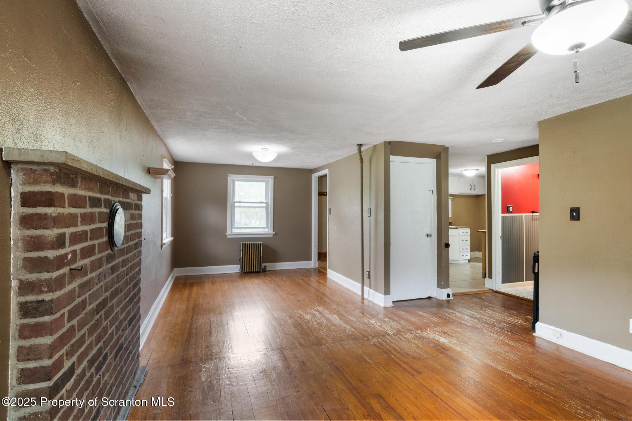 730 Chase Road Shavertown, PA 18708 - Photo 16 of 43 a view of an empty room with wooden floor and a window