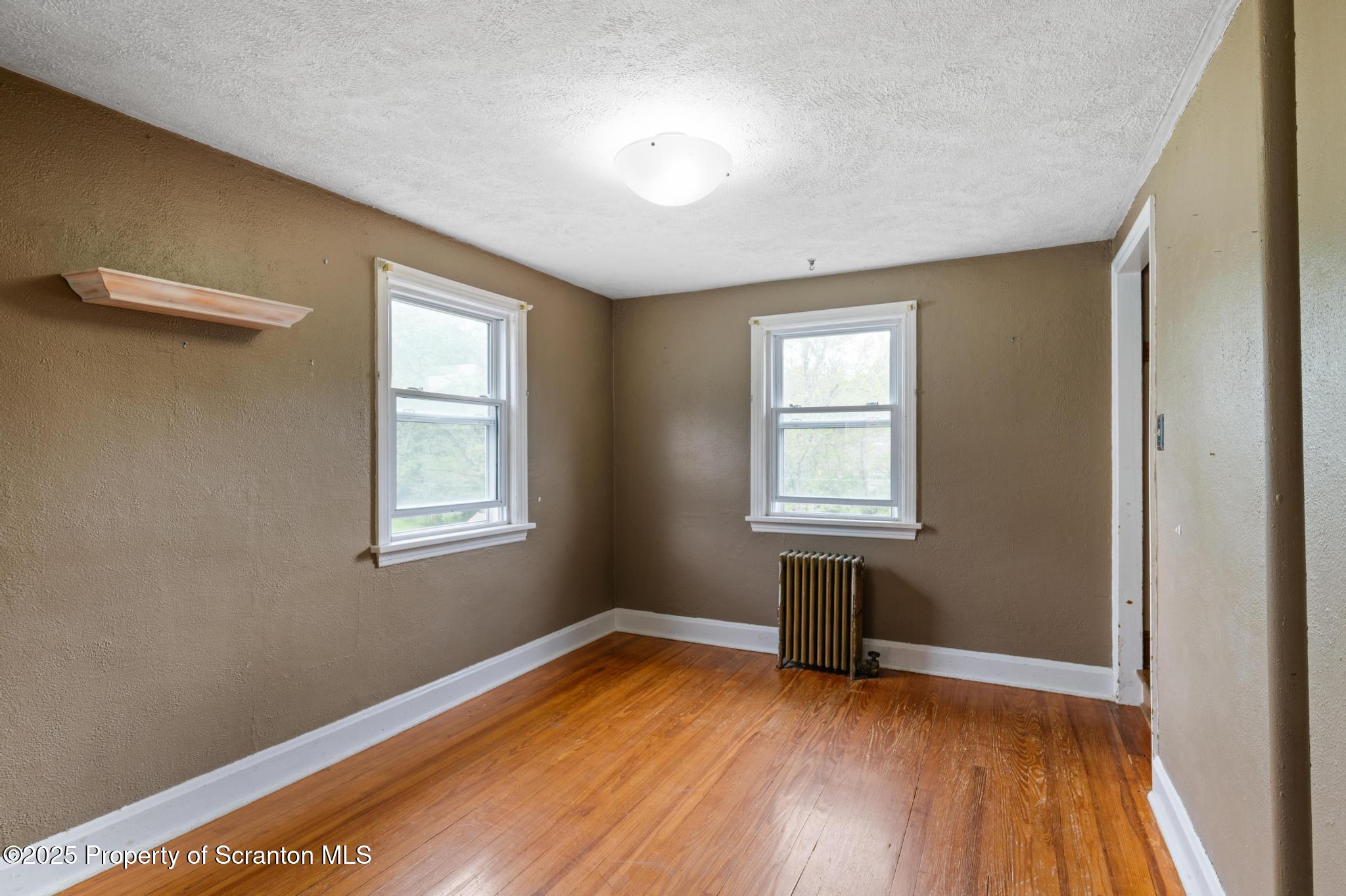 730 Chase Road Shavertown, PA 18708 - Photo 17 of 43 a view of empty room with wooden floor and fan