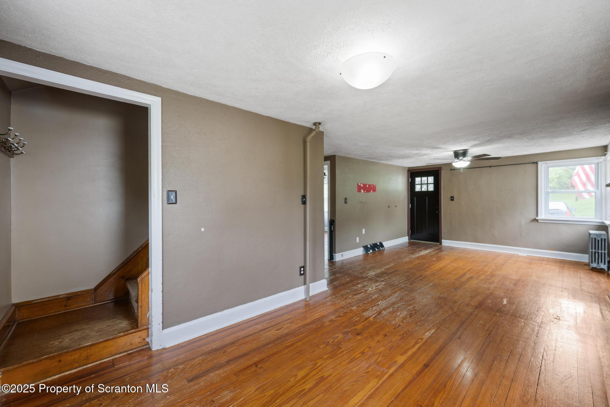730 Chase Road Shavertown, PA 18708 - Photo 18 of 43 a view of empty room with wooden floor and fan