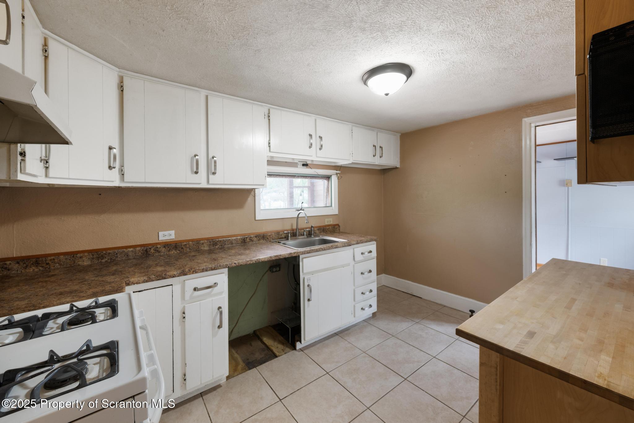 730 Chase Road Shavertown, PA 18708 - Photo 19 of 43 a kitchen with granite countertop white cabinets and white appliances