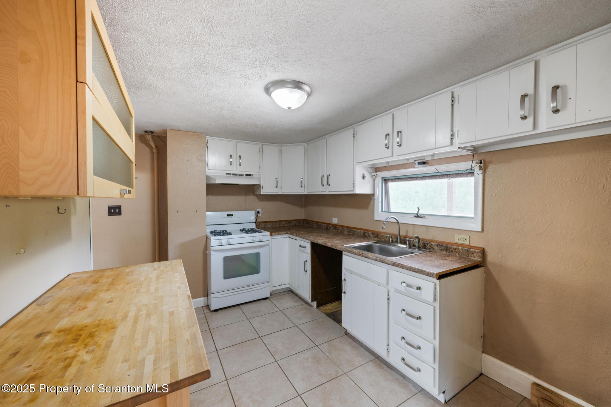 730 Chase Road Shavertown, PA 18708 - Photo 20 of 43 a kitchen with white cabinets stainless steel appliances and a sink