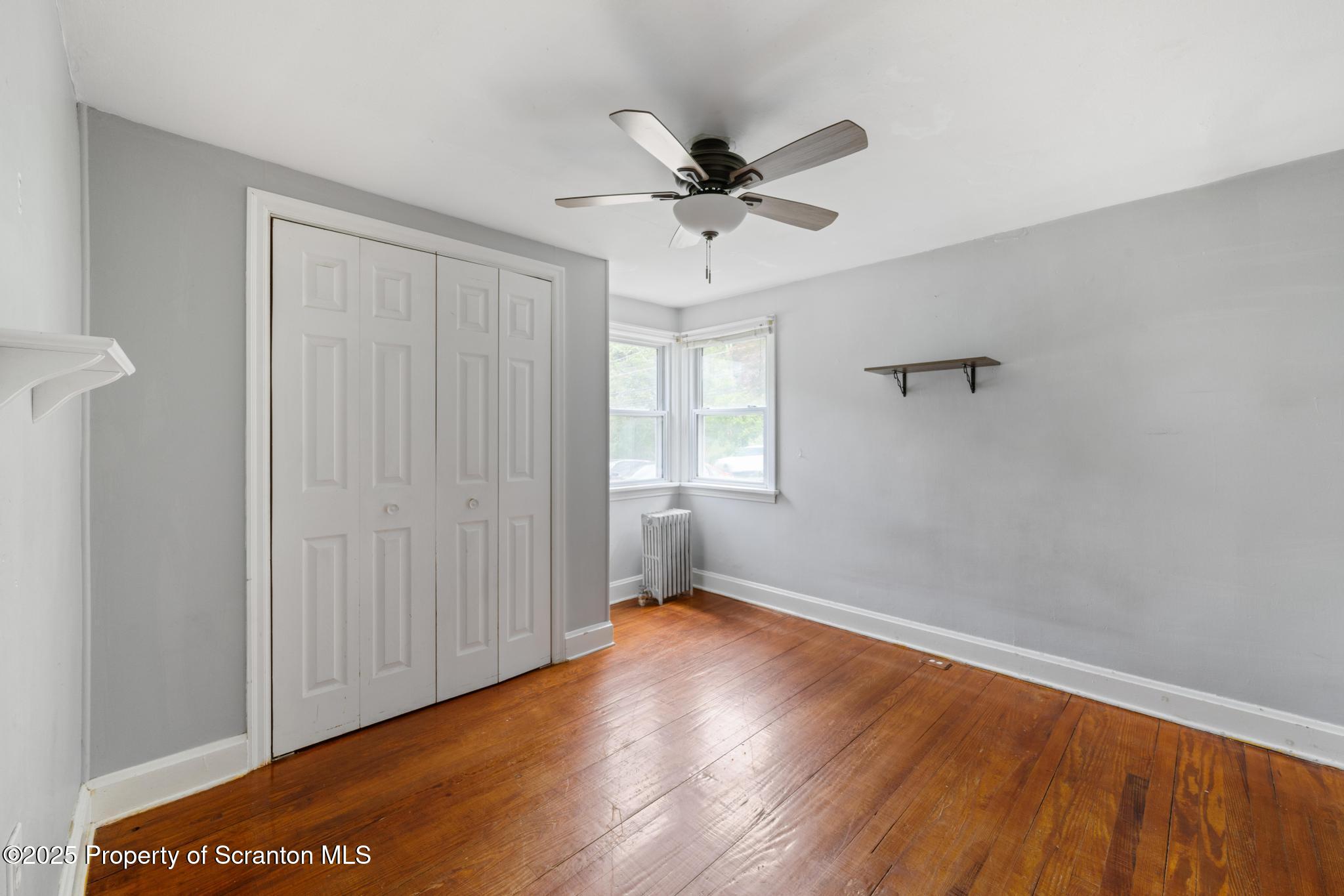 730 Chase Road Shavertown, PA 18708 - Photo 29 of 43 an empty room with wooden floor fan and windows